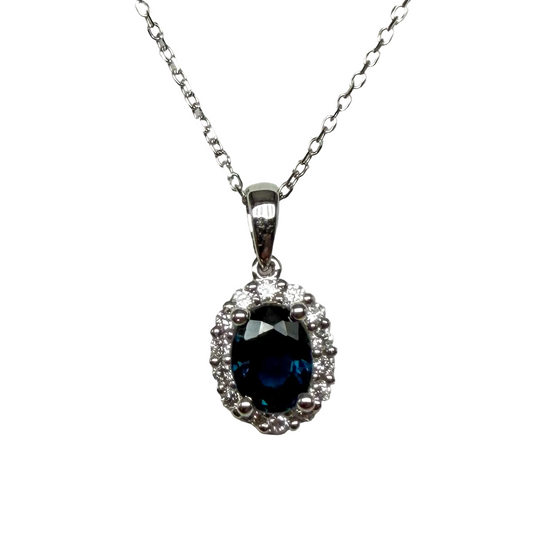 Oval blue sapphire pendant necklace with diamond halo on white gold chain